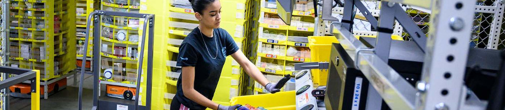 Amazon employee sorting yellow boxes in the fulfillment center