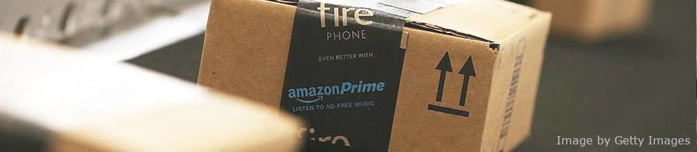 Amazon Prime box with Fire Phone sticker on it moving on conveyor belt of Amazon fulfillment center