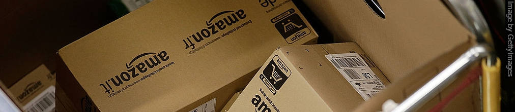 Pile of boxes with Amazon.fr and Amazon.it logos in a trolly