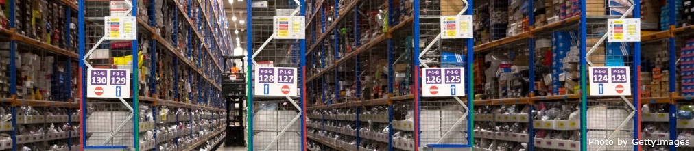 High shelves in Amazon fulfillment center full of boxes and containers