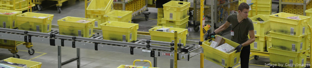 Amazon employee moving yellow boxes