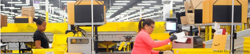 Two employees sorted boxes on conveyor tape at Amazon fulfilment center