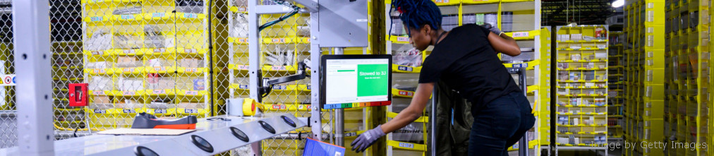 Amazon employee operating personal computer at fulfilment center