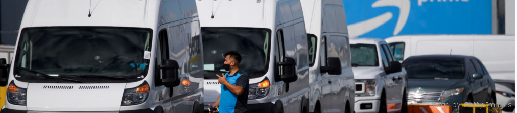 Amazon employee checking van next to fulfilment center