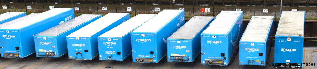 Blue Amazon trucks at the parking lot in fulfillment center