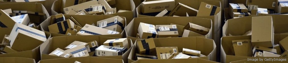 Carton boxes with Amazon logo on the shelf of fulfilment center