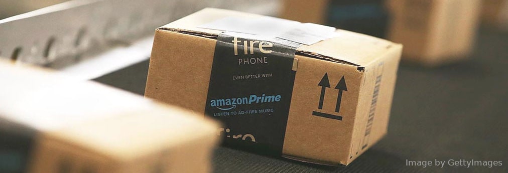 Tiny square box with Amazon Prime stickers moving on conveyor belt